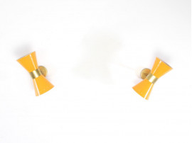 Mid century modern pair of yellow Diabolo wall lamp.