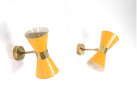 Mid century modern pair of yellow Diabolo wall lamp.